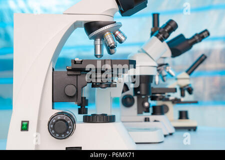 Four microscopes of different designs in the laboratory Stock Photo