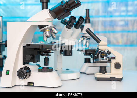 Four microscopes of different designs in the laboratory Stock Photo