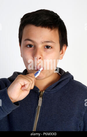 12-year-old boy brushing his teeth. Stock Photo