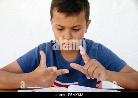 11-year-old boy doing homework in Salento, Italy. Stock Photo