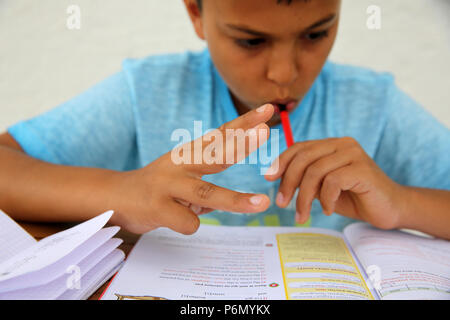 11-year-old boy doing homework in Salento, Italy. Stock Photo