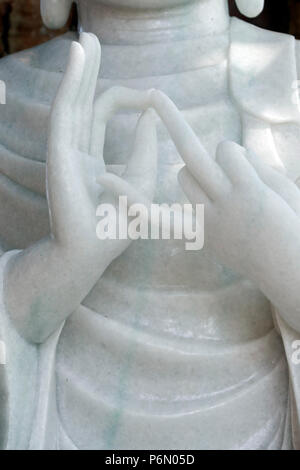 Thien Hoa buddhist pagoda.  Marble Buddha statue.  Mudra. Close-up.  Cai be. Vietnam. Stock Photo