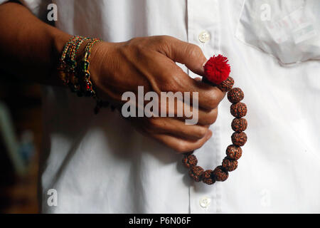 A man praying Mala beads, the Buddhist prayer beads. Close-up.  Cai be. Vietnam. Stock Photo