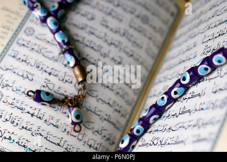 Arabic Holy Quran and a prayer beads. Stock Photo