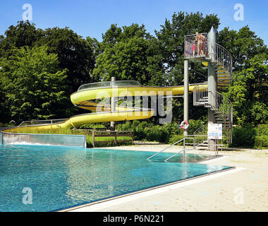 MUNICH, GERMANY -JUNE 11, 2018  curved slide and trees, natural environment for leisure and fun at Ungarerbad,  swimming bath in Munich Stock Photo