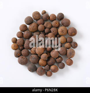 pile of whole allspice berries on white background Stock Photo