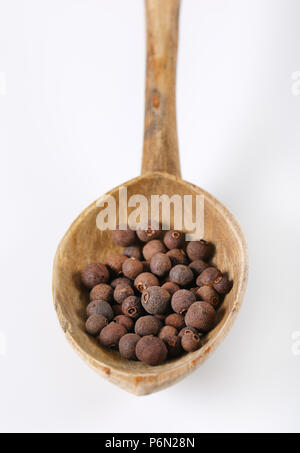 spoon of whole allspice berries on white background Stock Photo