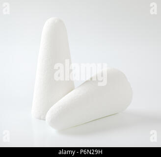 two white sugar loaves or cones on white background Stock Photo