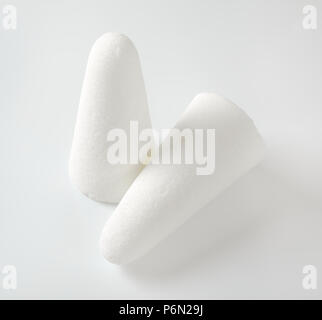 two white sugar loaves or cones on white background Stock Photo