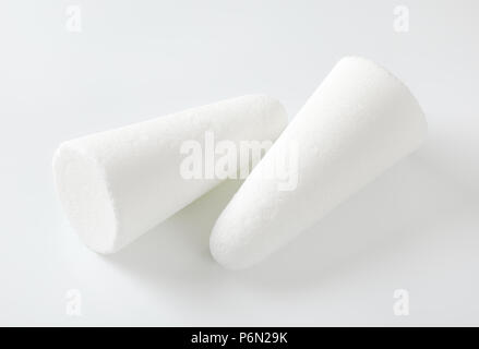 two white sugar loaves or cones on white background Stock Photo