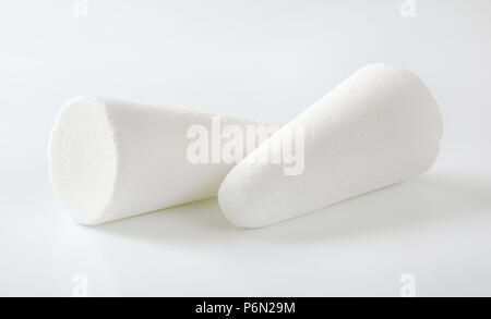 two white sugar loaves or cones on white background Stock Photo