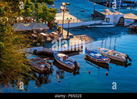 View of fishing motor boats on Lake Voulismeni in Agios Nikolaos, Crete, Greece Stock Photo