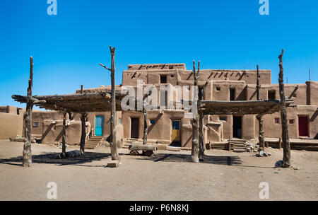 Adobe Buildings with Shade Structures. Taos Pueblo, New Mexico, continuously inhabited for over 1000 years. Stock Photo