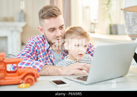 Father and Son Using Laptop Stock Photo