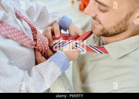 Father and Son Tying Neckties Stock Photo
