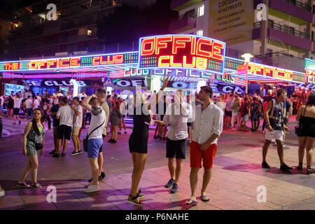 Magaluf tourists Punta Ballena nightclub, Crowd of people tourists walking in street, Mallorca Spain vacation Europe Stock Photo