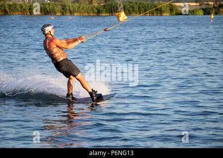 PASOHLAVKY, CZECH REPUBLIC - JUNE 03, 2017: Rider wakeboarding in the cable wake park Merkur in the Palava region in South Moravia Stock Photo