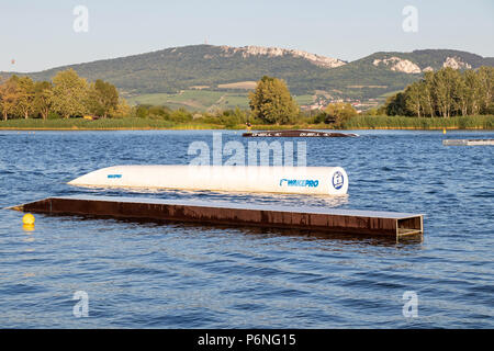 PASOHLAVKY, CZECH REPUBLIC - JUNE 03, 2017: Wakeboard obstacles in the cable wake park Merkur in South Moravia, with Palava mountains in the backgroun Stock Photo