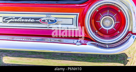 Shallow depth of field closeup of the taillight assembly and rear nameplate on a 1964 Ford Galaxie 500 XL convertible. Stock Photo