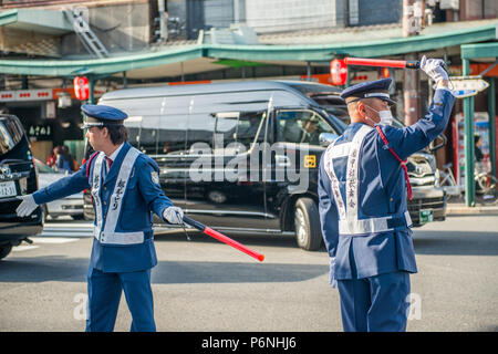 Japanese traffic police in action on a busy street in the Gion district of Kyoto Stock Photo