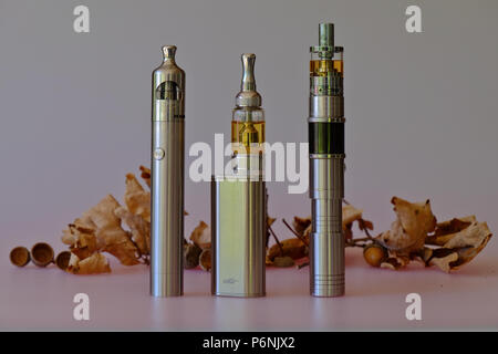 3 different vape pen electronic cigarette devices juul, aspire breeze, smok  infinix, with a pack of Marlboro Gold cigarettes in the background out of  Stock Photo