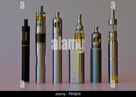 3 different vape pen electronic cigarette devices juul, aspire breeze, smok  infinix, with a pack of Marlboro Gold cigarettes in the background out of  Stock Photo