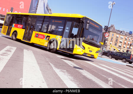 Copenhagen, Denmark - June 27, 2018: One yellow city bus in service on line 14 turning in downtown Copenhagen. Stock Photo