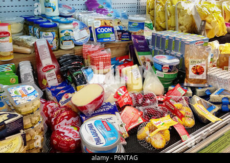 Bali, Jimbaran, 2018-04-28: Shelf in grocery store with huge selection of various delicacies cheeses in different packages, shapes, types. Stock Photo
