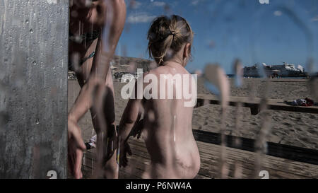 Mom is washing her daughter in beach shower Stock Photo - Alamy