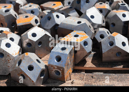 Modern industrial scaffolding steel connection parts lay on wooden floor Stock Photo