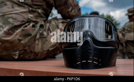A paintball mask sits on a picnic table during a Delta Detachment, 1st Space Company, Joint Tactic Army Ground Station exercise at Misawa Air Base, Japan, June 22, 2018. With the JTAGS detachment eight hours away from the nearest U.S. Army base, it is important to build, bond and network with sister services. The remote location gives soldiers an opportunity to see how sister branches operate. The tasks in the exercise are important to the Army and Soldiers in Misawa because no matter where they are, the same tasks are taught. After a long day of learning battle drills, reports and Self-Aid Bu Stock Photo