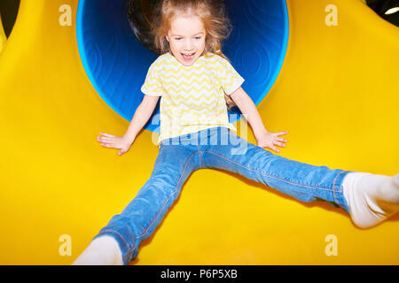 Happy Girl Going Down Slide Stock Photo