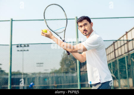 Determined tennis player looking forward with concentration Stock Photo