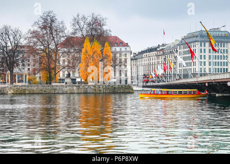 Geneva, Switzerland - November 26, 2016: Passenger boat with people on board goes under Mont-Blanc bridge. One of Mouettes, small yellow water taxis a Stock Photo