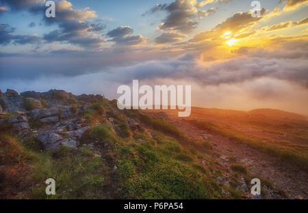 Mountain mist at sunrise with clouds Stock Photo