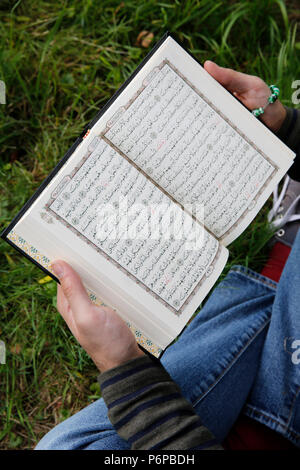 Young man reading the Kuran. France. Stock Photo
