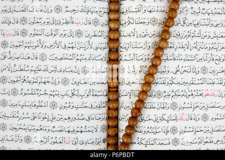 Open Kuran and prayer beads. France. Stock Photo