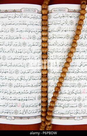Open Kuran and prayer beads. France. Stock Photo