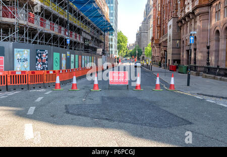 Cones and a Road Closed sign indicate a closed off road in Manchester city centre, UK. Stock Photo