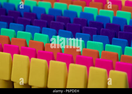 Rows of brightly colored pencil erasers lined up in an OCD orderly fashion with a high contrast lighting and a shallow depth of field and a tight fram Stock Photo