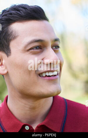 Outdoor Head And Shoulders Portrait Of Smiling Young Man Stock Photo