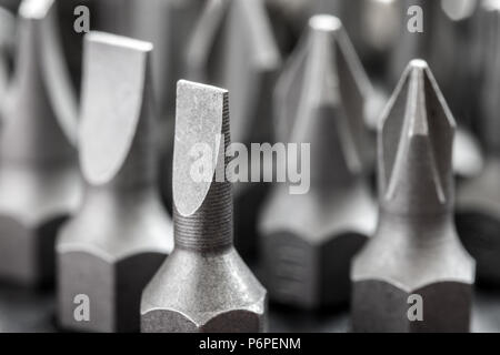 Set of bits for the screws. Selection of different shapes and bits for a screwdriver. Macro view of tools. Stock Photo