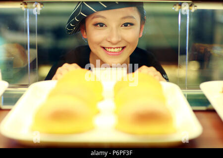 female baker in bakery working Stock Photo