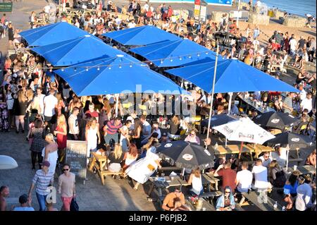 People having fun on a summers evening on Brighton seafront Stock Photo