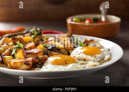 Eggs and Fries with small pieces of fat pork meat, onion and garlic on plate Stock Photo