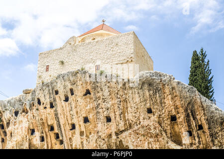 St. John 'Al-Sheer' Church sitting on a cliff above man-made crypts, Amioun, Lebanon Stock Photo