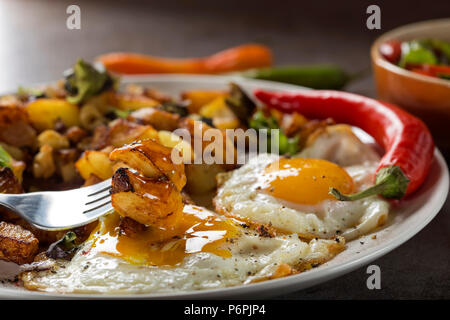 Eating Eggs and Fries with small pieces of fat pork meat, onion and garlic Stock Photo