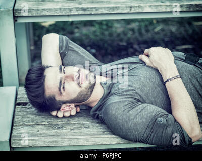 Attractive young man in city park in a summer day Stock Photo