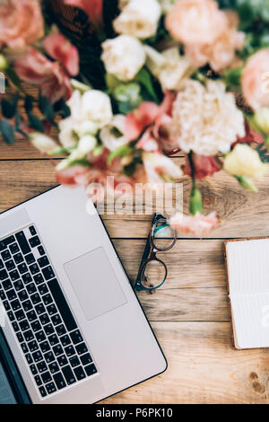 Flat lay of stylish male workplace with clip folder, laptop and