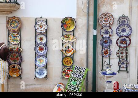 ALCOBACA, PORTUGAL - MAY 22, 2018: Ceramic plates in a souvenir shop in Alcobaca. 21.2 million tourists visited Portugal in 2016. Stock Photo